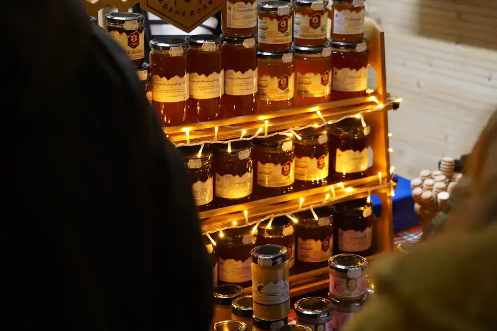 A row of honey jars filled with golden urban harvest